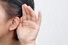 Hand cupping ear to help with hearing