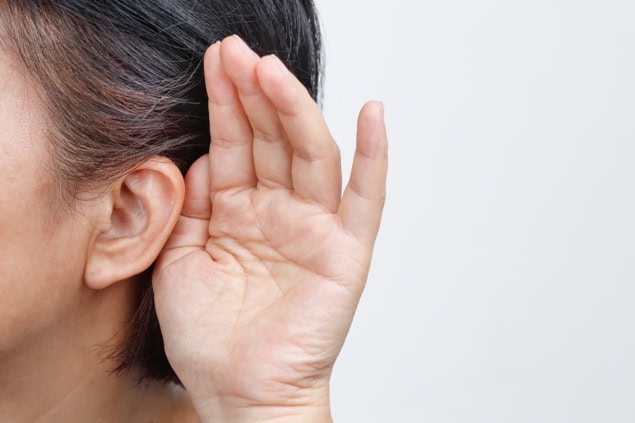 Hand cupping ear to help with hearing